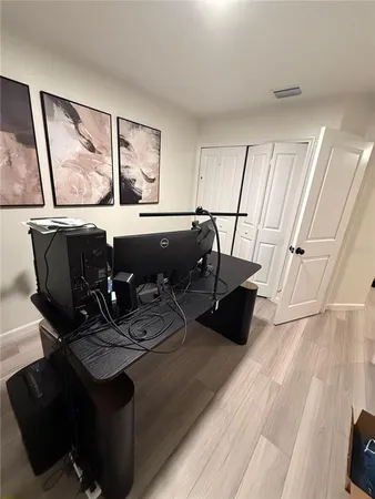 a view of a room with wooden floor