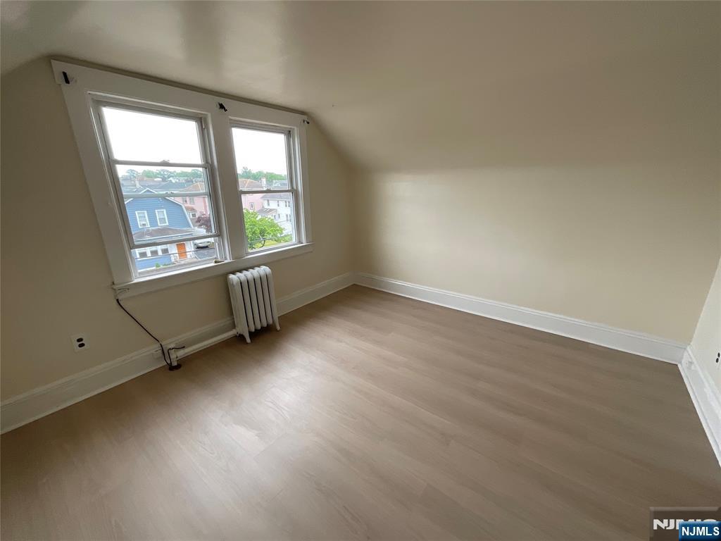 131 Delafield Avenue, Unit 3 Lyndhurst, NJ 07071 - Photo 12 of 15 an empty room with wooden floor and windows