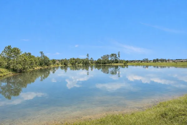 a view of a lake with houses in the background