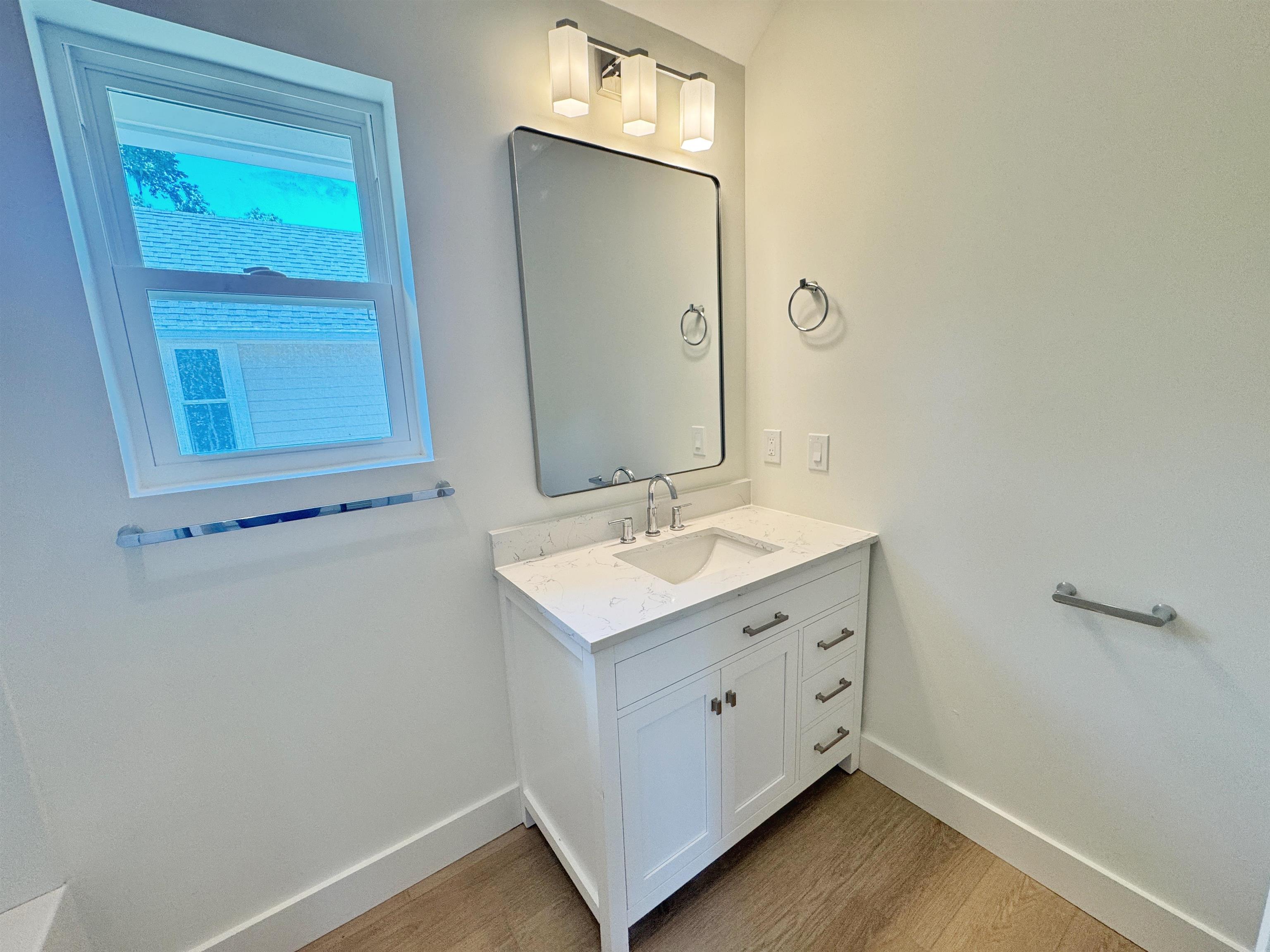 932 Alexander Street St. Augustine, FL 32084 - Photo 20 of 28 a bathroom with a sink and a mirror