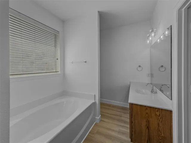 a bathroom with a sink a shower and a mirror