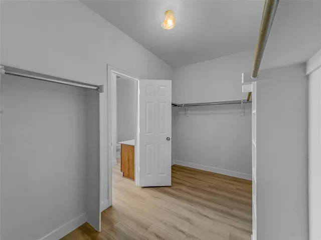 a bathroom with a tub a sink and mirror