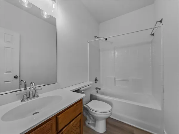 an empty room with window and ceiling fan