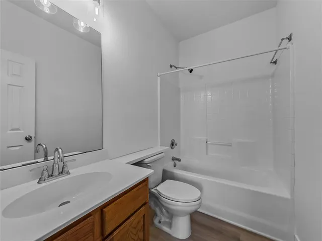 an empty room with window and ceiling fan