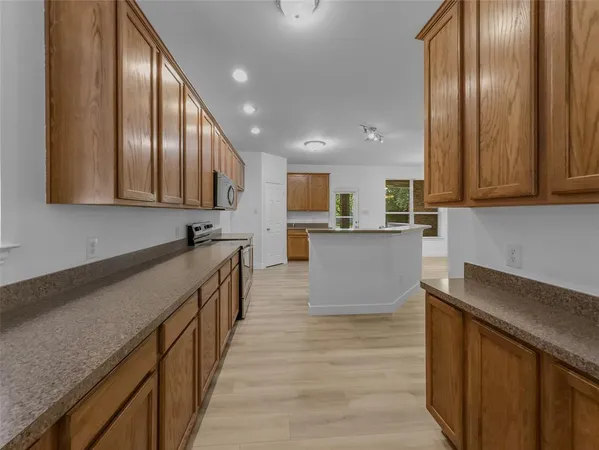 a large kitchen with stainless steel appliances lots of counter space and a sink