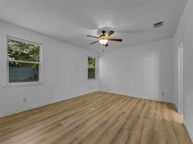 a kitchen with stainless steel appliances granite countertop wooden cabinets a refrigerator and a sink