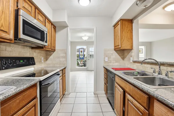 a kitchen that has a sink and a stove