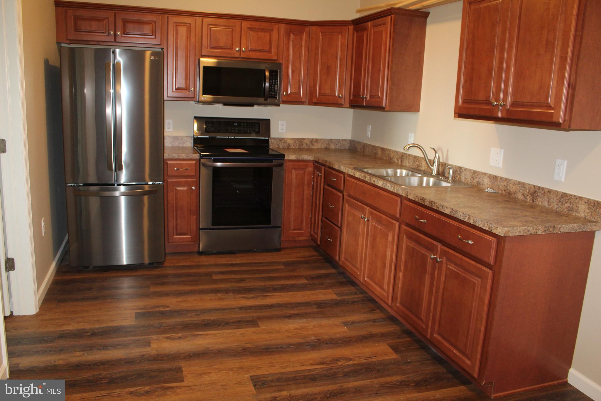 2560 Freysville Road, Unit B Red Lion, PA 17356 - Photo 3 of 6 a kitchen with stainless steel appliances granite countertop a refrigerator stove and sink
