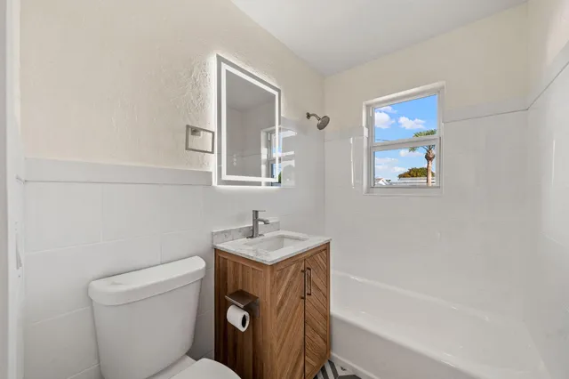 a bathroom with a sink a toilet and a bathtub