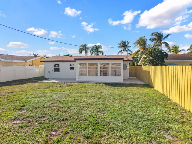 a view of a house with a backyard and a garden