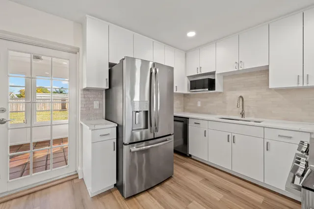 a kitchen with a refrigerator sink and microwave