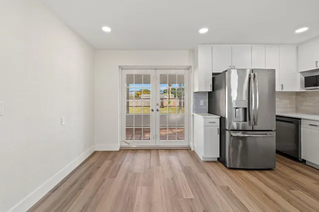 a kitchen with stainless steel appliances a refrigerator and a stove top oven
