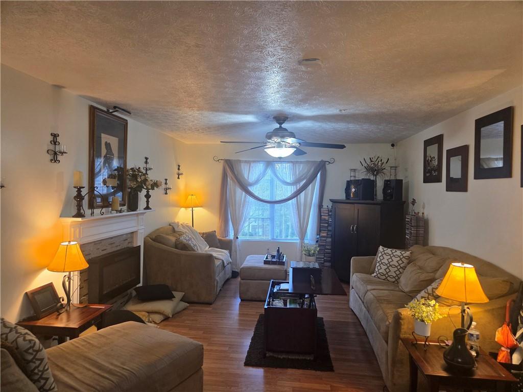 5303 Par 4 Way Lithonia, GA 30038 - Photo 6 of 28 a living room with furniture a lamp and a fireplace