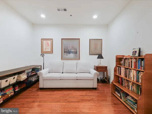 a living room with furniture and a book shelf