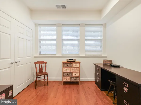 a view of a workspace with furniture and a window