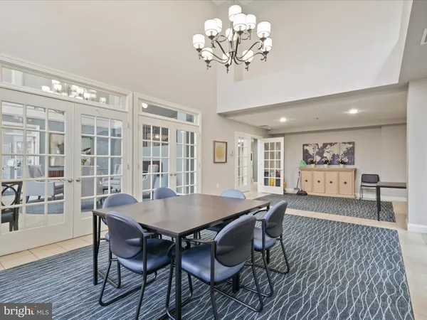 a view of a dining room with furniture wooden floor and chandelier