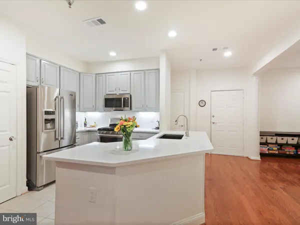 a kitchen with refrigerator and cabinets