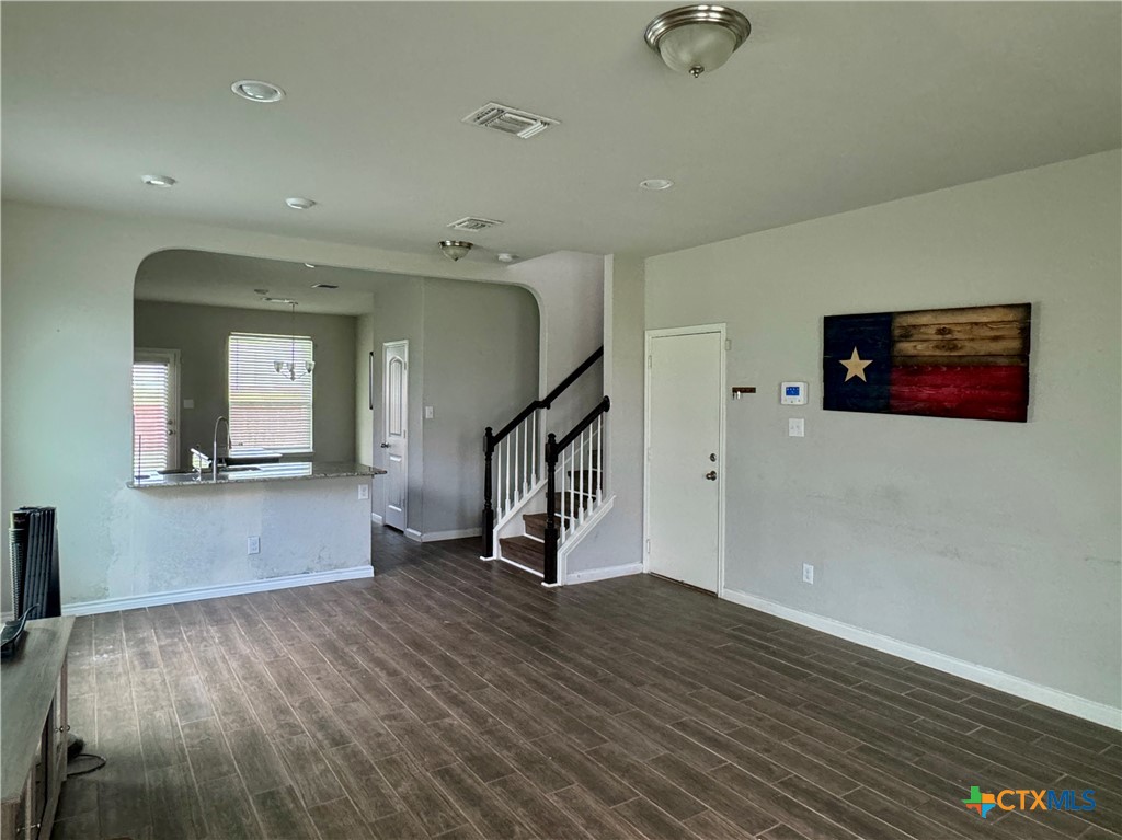 942 Pumpkin Ridge New Braunfels, TX 78130 - Photo 3 of 18 a view of an empty room with wooden floor and stairs
