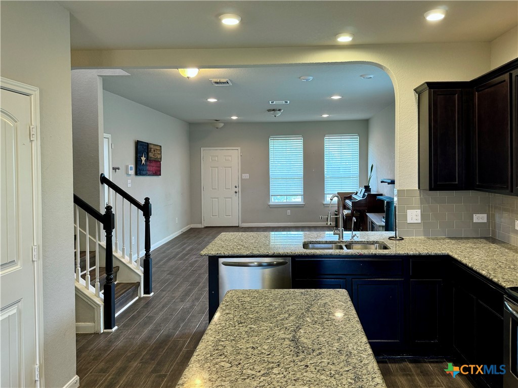 942 Pumpkin Ridge New Braunfels, TX 78130 - Photo 5 of 18 a kitchen with kitchen island stainless steel appliances a sink stove and refrigerator