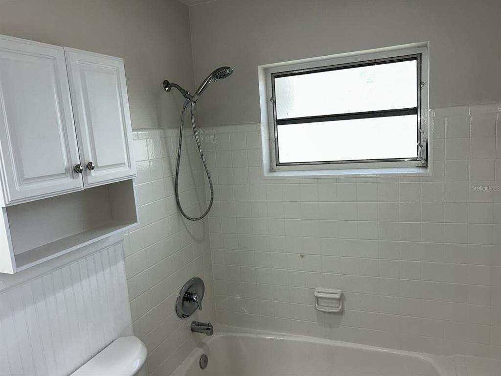 1241 Pilgrim Road Spring Hill, FL 34606 - Photo 17 of 28 a bathroom with a bath tub with a shower