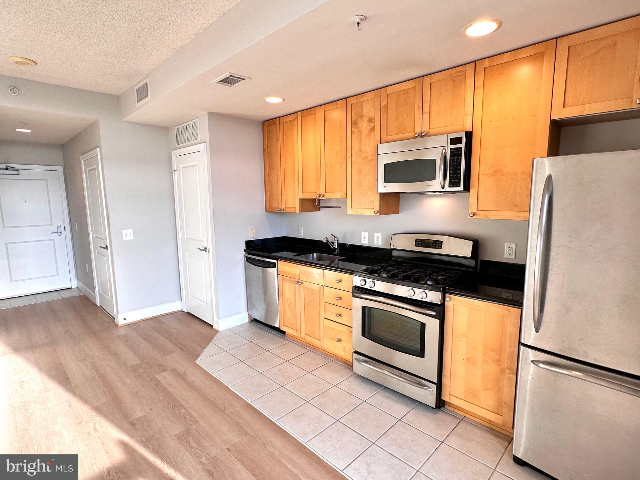 3600 South Glebe Road, Unit 507W Arlington, VA 22202 - Photo 2 of 23 a kitchen with granite countertop stainless steel appliances a stove a sink and a refrigerator