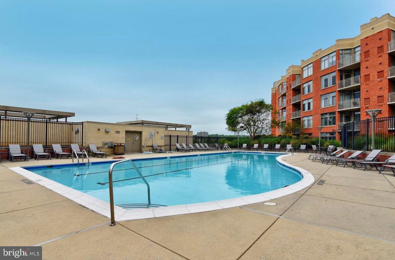 3600 South Glebe Road, Unit 507W Arlington, VA 22202 - Photo 22 of 23 a view of swimming pool with outdoor seating and a potted plant