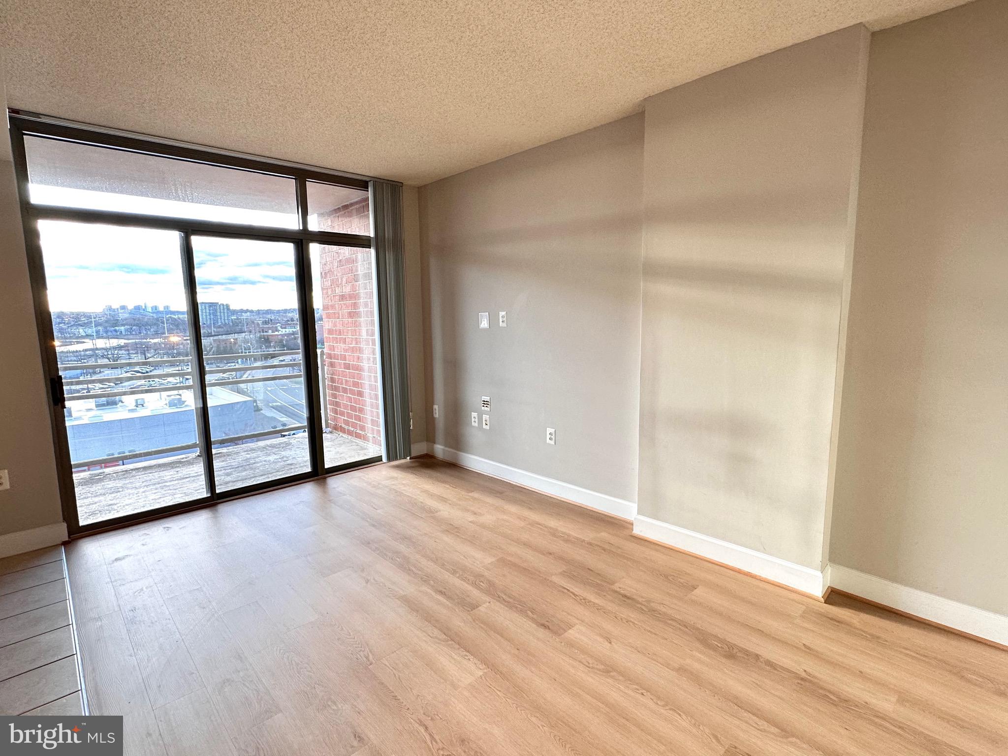 3600 South Glebe Road, Unit 507W Arlington, VA 22202 - Photo 8 of 23 a view of an empty room with wooden floor and a window