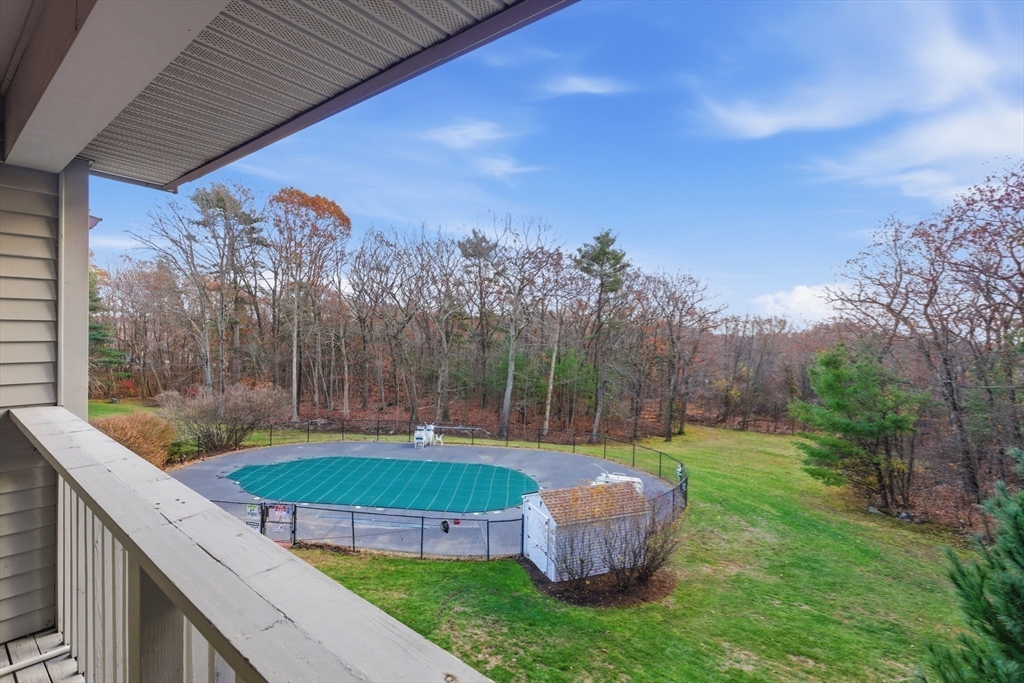 2211 Franklin Crossing Road, Unit 2211 Franklin, MA 02038 - Photo 13 of 32 a view of a chairs and table in the backyard