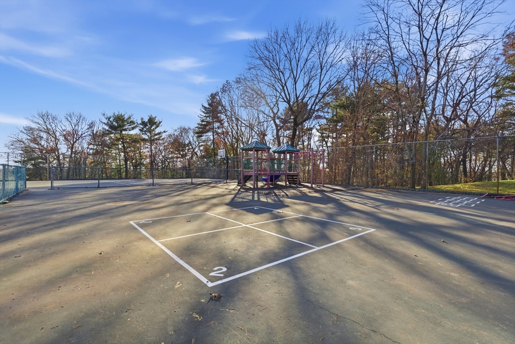 2211 Franklin Crossing Road, Unit 2211 Franklin, MA 02038 - Photo 23 of 32 a view of a playground with large trees