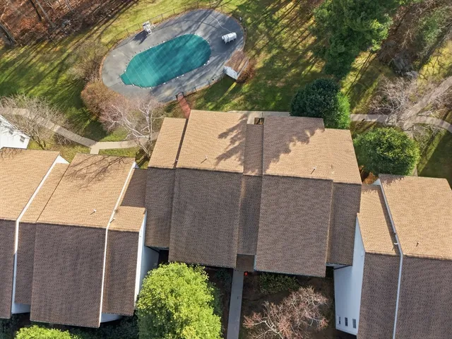an aerial view of a house with yard swimming pool and outdoor seating