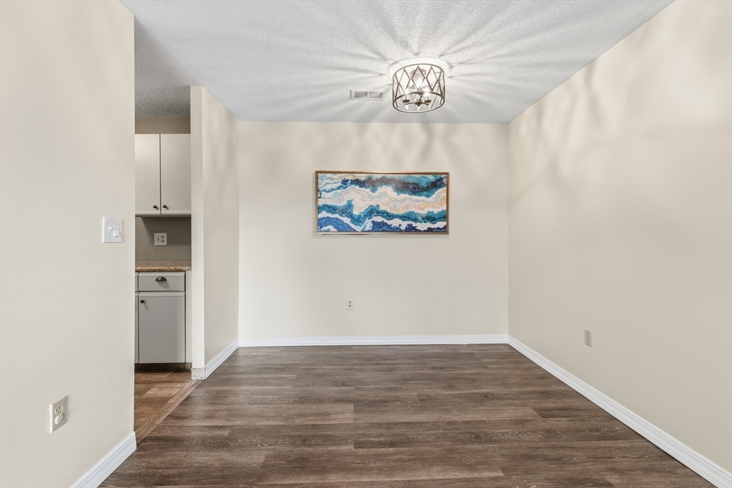2211 Franklin Crossing Road, Unit 2211 Franklin, MA 02038 - Photo 6 of 32 wooden floor in an empty room with a window