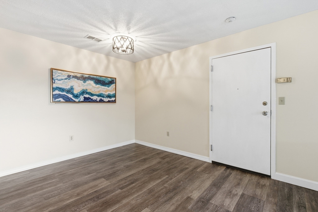 2211 Franklin Crossing Road, Unit 2211 Franklin, MA 02038 - Photo 7 of 32 a view of an empty room with wooden floor