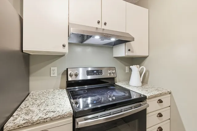 a stove top oven sitting inside of a kitchen