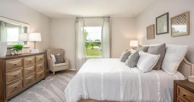 a bedroom with a bed a couch and dresser