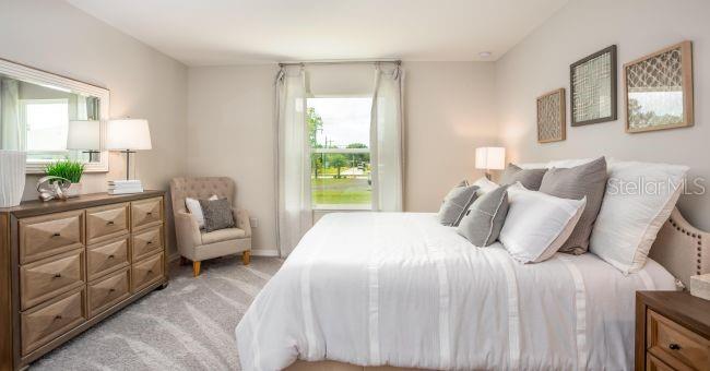 5268 Hanford Avenue Spring Hill, FL 34608 - Photo 8 of 14 a bedroom with a bed a couch and dresser