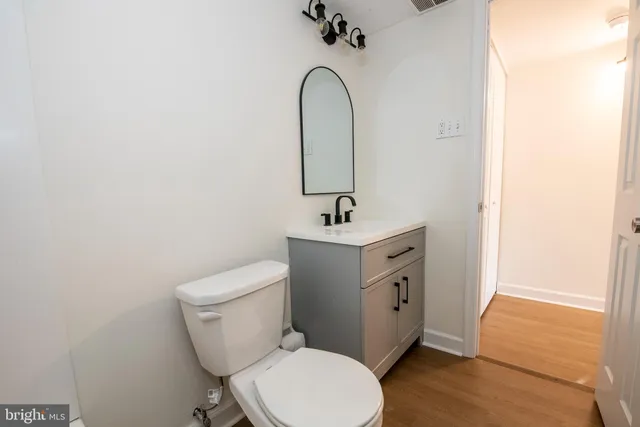 a bathroom with a toilet sink and mirror