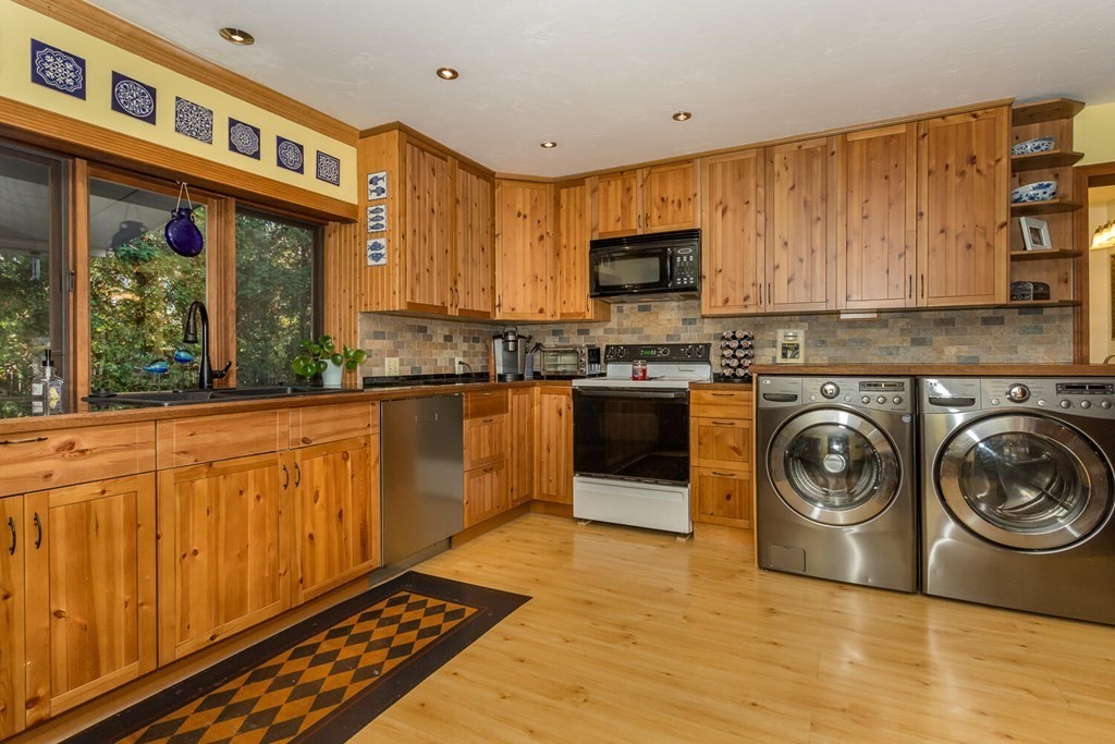 49 Pleasant Circle Canton, MA 02021 - Photo 11 of 25 a kitchen with stainless steel appliances granite countertop a stove a sink and a microwave
