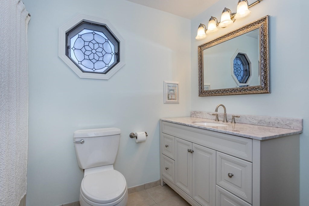 49 Pleasant Circle Canton, MA 02021 - Photo 14 of 25 a bathroom with a toilet a sink and a mirror