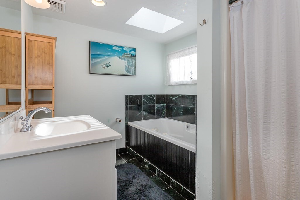 49 Pleasant Circle Canton, MA 02021 - Photo 17 of 25 a en suite bathroom with a sink and a mirror