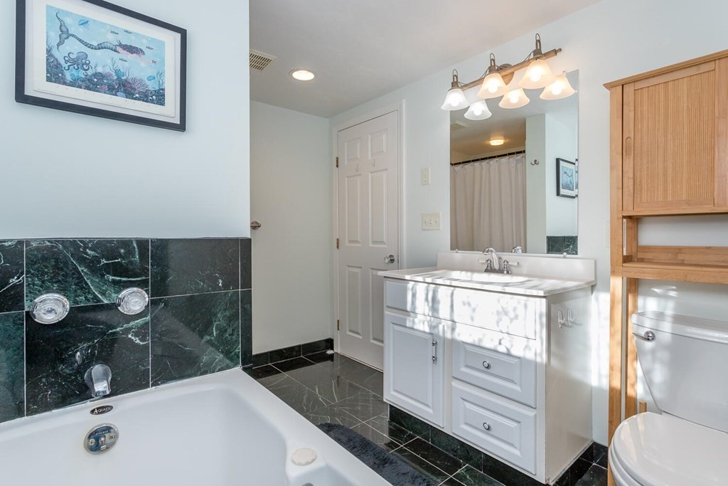 49 Pleasant Circle Canton, MA 02021 - Photo 18 of 25 a bathroom with a granite countertop sink mirror vanity and toilet