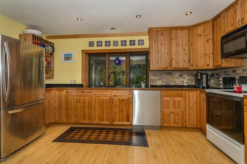 49 Pleasant Circle Canton, MA 02021 - Photo 10 of 25 a kitchen with stainless steel appliances a refrigerator and a stove top oven