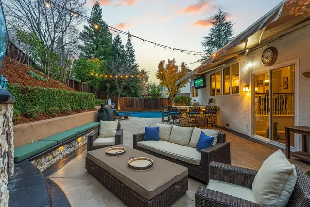 a backyard of a house with table and chairs