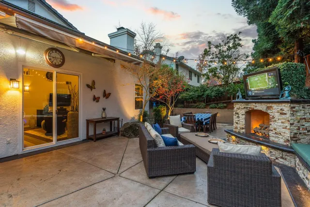 a view of a house with backyard sitting area and garden