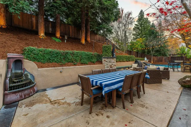 a view of a livingroom with furniture a ceiling fan and wooden floor
