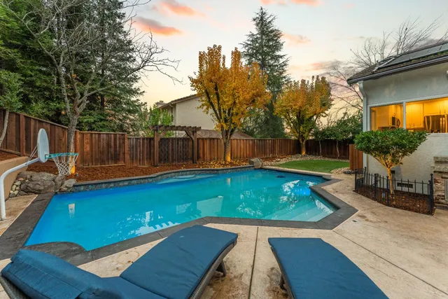 a living room with furniture fireplace and a large window