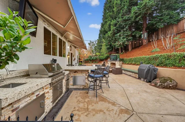 a bathroom with a granite countertop sink a mirror and shower