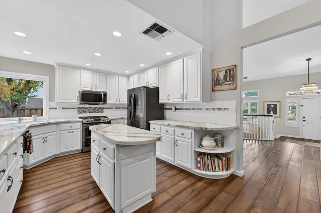 a bathroom with a granite countertop toilet a sink and a mirror