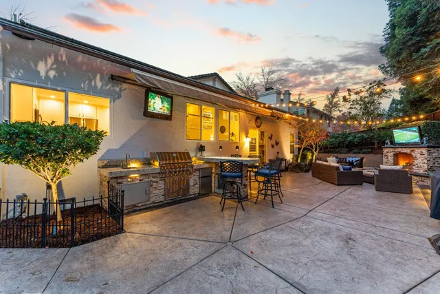 a view of a patio with table and chairs