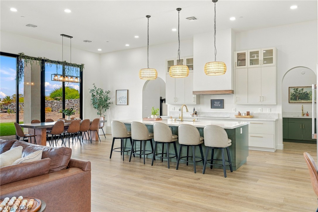 324 Wanda Road Henderson, NV 89002 - Photo 94 of 96 An open floorplan seamlessly connects the airy kitchen and dining area over light wood flooring.