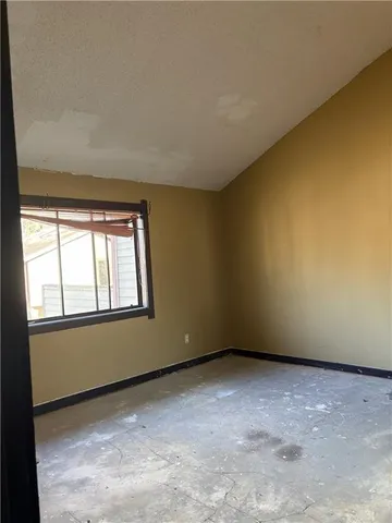 an empty room with a empty space and a window